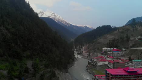 Aerial-View-Of-Kalam-Valley,-Swat-Valley-And-Snow-Capped-Mountains-In-The-Background