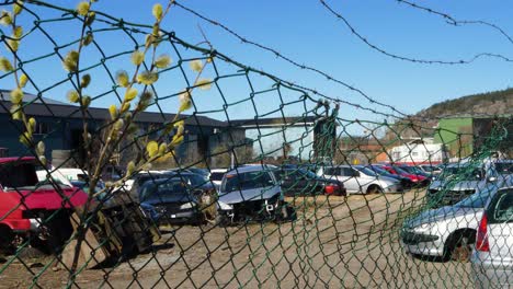 Gothenburg,-Sweden---Abril-28,-2021:-Crushed-Cars-Stacked-Up-For-Recycling-behind-the-fence