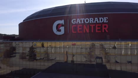 Aerial-view-panning-up-accross-the-main-entrance-and-above-the-roof-of-Gatorade-Center