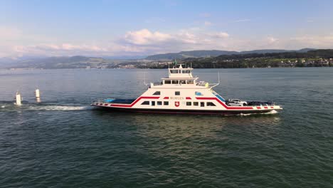 Aerial-drone-panning-shot-following-car-ferry-Horgen-leaving-Meilen-in-Switzerland