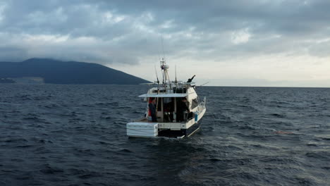 Fishermen-Catching-Tuna-From-Fishing-Vessel-Anchored-In-Wavy-Water-Of-Adriatic-Sea