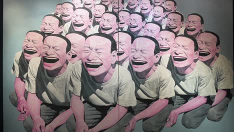 Chinese-artist-Yue-Minjun-art-piece-named-"Self-portrait",-depicting-himself-while-grinning-with-his-mouth-gaping,-at-the-world's-largest-brokers-modern-collectibles-Sotheby's-show-in-Hong-Kong