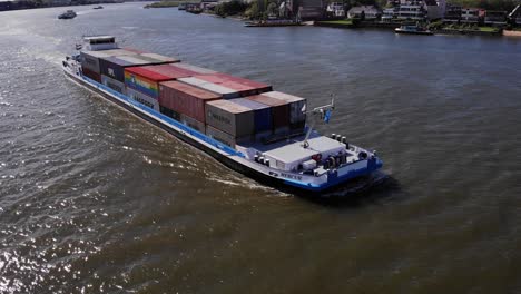 Containers-Freighted-In-Cargo-Ship-Sails-On-The-Waters-In-Molenlanden,-South-Holland