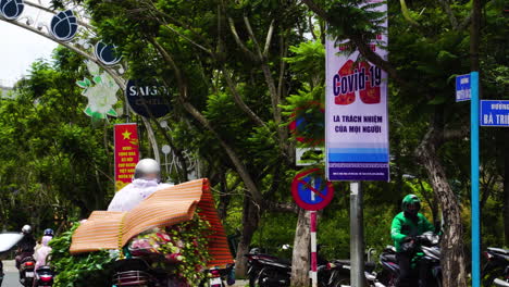 Motorcyclists-with-Covid-face-mask-riding-through-the-street-in-Da-Lat,-Vietnam