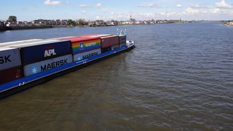 Large-Cargo-Ship-Of-Mercur-With-Container-Goods-And-Vehicles-Travels-The-River-In-Molenlanden-Province