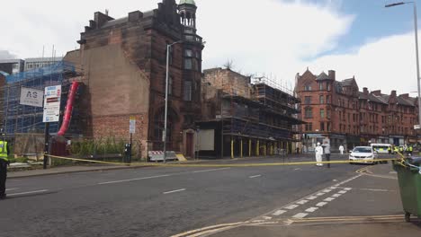 A-crime-scene-photographer-and-a-man-talking-about-the-fire-damage-of-old-Victorian-buildings