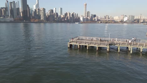 Piers-and-Long-Island-Sign-against-cityscape,-Queens,-New-York