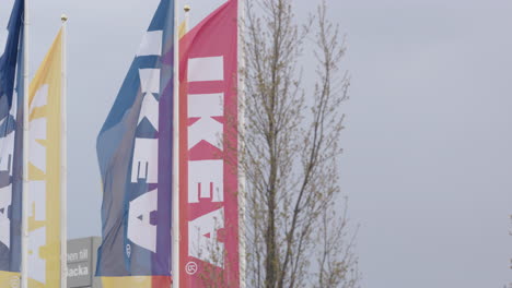 IKEA-flags-fly-in-a-carpark-in-Borlange,-Sweden