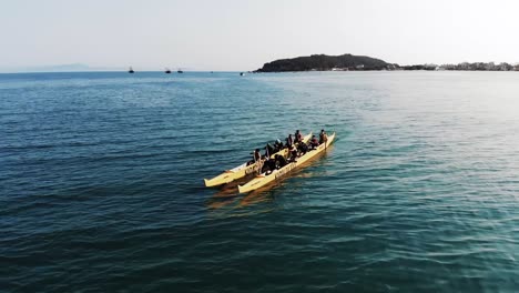 Aerial-orbiting-shot-showing-paddling-group-of-Brazilian-men-in-double-kayak-during-sunny-day