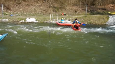 People-struggling-and-learning-to-kayak-and-canoe-on-fast-rapid-river,-Slovakia