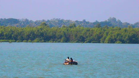 Two-people-sitting-in-a-dinghy-boat,-ocean-summer-concept