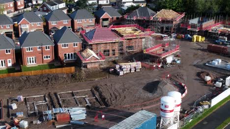 Construction-site-aerial-view-above-new-urban-real-estate-housing-development-regeneration-tilt-up-birdseye-reveal