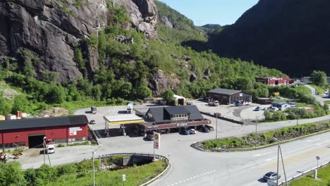 Slowly-rotating-and-approaching-aerial-of-popular-stopping-spot-with-cafe-and-gasoline-station-along-Bergen-Oslo-highway-E-16---Sunny-day-aerial-with-people-and-cars