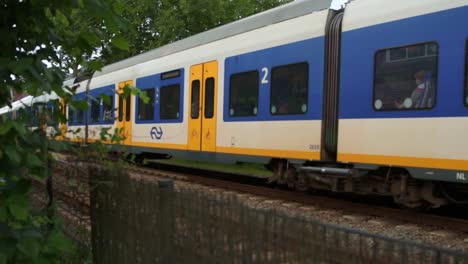 Dutch-train-passing-through-a-little-village-in-the-summer