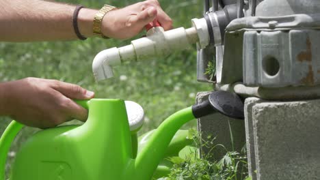 plastic-watering-can-filled-water-spigot-man-watch-outside-slow-motion