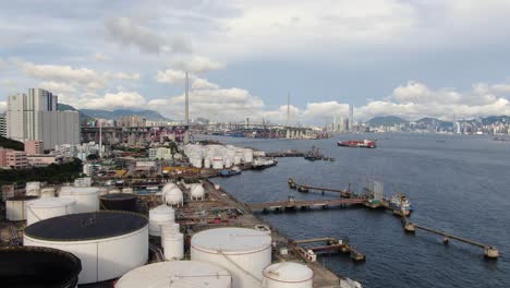 Hong-Kong-commercial-Port,-aerial-approach-passing-above-Oil-and-Chemical-storage-depot