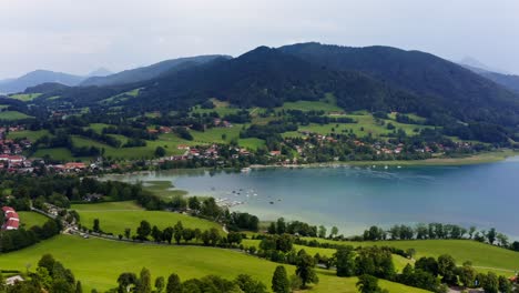 Panning-shot-over-the-Tegernsee,-a-popular-recreation-aera-lake-with-the-aerial-view-from-Gmund-over-the-beautyful-lake-in-mountain-range-next-to-the-alps