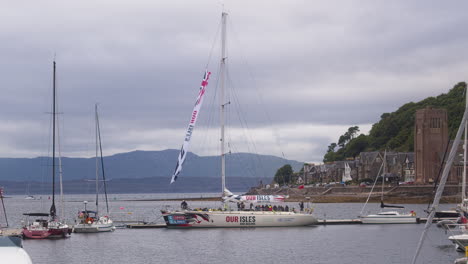 Clipper-Of-Our-Isles-And-Oceans-Floating-At-The-Resort-Town-Of-Oban,-Scotland-On-A-Cloudy-Day