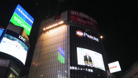 POV-Zu-Vielen-Bildschirmwerbetafeln-über-Dem-Gebäude-In-Der-Gegend-Von-Shibuya