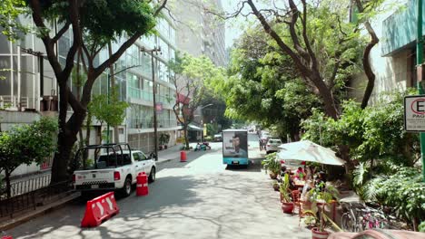 Aerial-dolly-in-tracking-shot-of-truck-at-street-in-la-condesa-Mexico-City