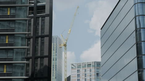 Manchester,-North-West,-England---July-20-2021:-Manchester-city-on-a-sunny-day-with-yellow-crane