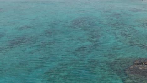 Crystal-clear-water-of-Mediterranean-sea-near-coastline-of-Crete-island,-aerial-drone-view