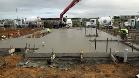 SLOW-MOTION-Wide-Shot-Of-New-House-Slab-Pour-Job-Site,-Cement-Still-Wet