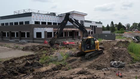 Caterpillar-excavator-removing-fencing-and-grass-in-ankeny-iowa