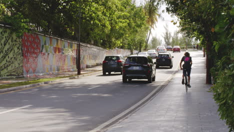 Local-Man-Riding-Bicycle-on-San-Juan-Street-Sidewalk-in-Puerto-Rico,-Static