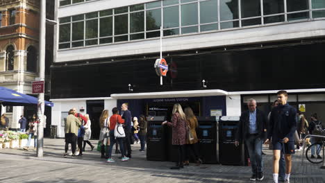 People-Outside-Sloane-Square-Station-Entrance-In-Central-London---9th-October-2021