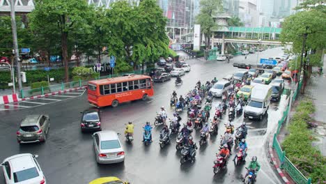 Traffic-through-busy-intersections-at-rush-hour-in-Bangkok-which-is-controlled-by-traffic-lights,-there-is-heavy-traffic-every-day