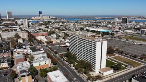 A-wide-orbiting-aerial-view-of-downtown-tourist-district-of-Atlantic-City,-New-Jersey-on-a-sunny-autumn-day