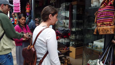 Europeans-Tourists-Shopping-From-A-Local-Souvenir-Shop-In-Peru