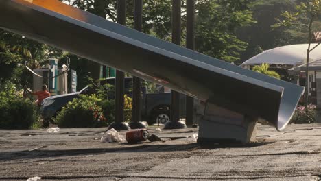 A-dolly-shot-of-a-slide-of-a-children’s-playground,-tilting-down-to-reveal-the-unpleasant-sight-of-trash-and-litter-which-has-been-dropped-on-the-ground,-Causeway-of-Amador,-Panama-City