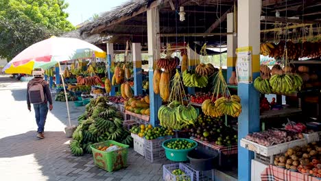 A-man-shopping-for-fresh-produce-and-groceries-at-traditional-local-fruit-and-vegetable-market-in-the-capital-of-Dili,-Timor-Leste,-Southeast-Asia