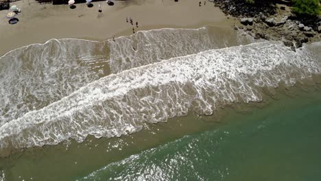 drone-shot-of-waves-crashing-on-the-sand