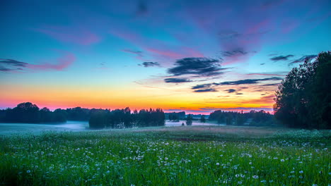 Blue,-white,-orange,-red,-violet-and-purple-sky-in-foggy-meadow-landscape