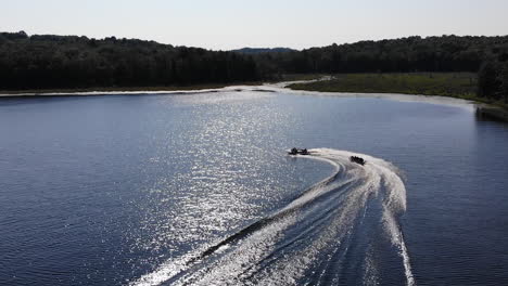 Boat-tows-tube-on-the-lake-in-the-Pocono-Mountains-during-golden-hour