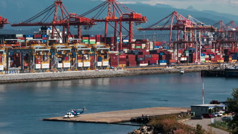 Helicopter-Arriving-And-Landing-At-HeliJet-Helipad-In-Vancouver-Harbour-In-Canada-With-Port-Cranes-In-Background