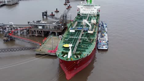Silver-Rotterdam-oil-petrochemical-shipping-tanker-loading-at-Tranmere-terminal-Liverpool-aerial-view-left-orbit-low