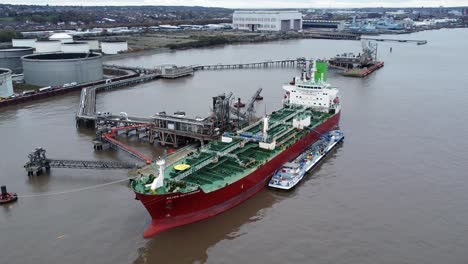 Silver-Rotterdam-oil-petrochemical-shipping-tanker-loading-at-Tranmere-terminal-Liverpool-aerial-view-right-orbit-shot