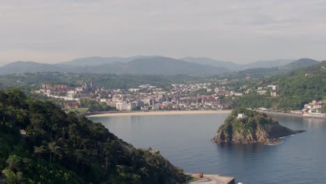 Beautiful-hilly-landscape-and-city-of-San-Sebastian,-aerial-drone-view