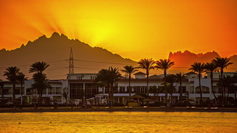 Sunset-on-the-Red-Sea-with-the-Beach-Albatros-Resort-beneath-the-rugged-mountains-of-Egypt