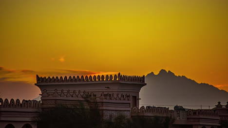 Sunset-time-lapse-of-a-resort-façade-and-the-mountains-at-Hurghada,-Egypt