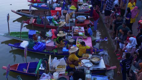 High-angle-shot-over-Khlong-Hae-Floating-Market-with-waterfront-community-selling-local-products-to-tourists-and-locals-tasty-food-in-Songkhla-province,-Thailand-during-evening-time