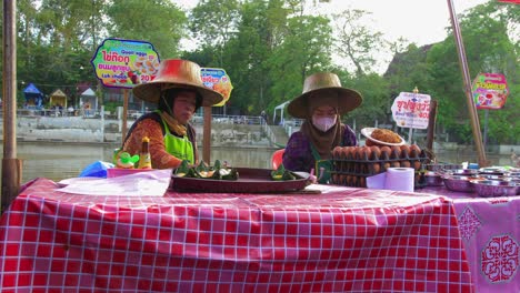 Two-local-asian-Thai-women-preparing-snack-to-sell-in-asian-street-market-at-day-time