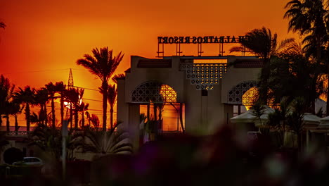 Sunset-time-lapse-from-behind-the-sign-for-the-Beach-Albatros-Resort---on-a-breezy-day