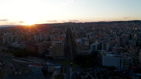 Aerial-View-Over-Catania-Municipality-With-Orange-Sunset-On-Horizon