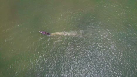 Victoria-Island-Lagos,-Nigeria---20-November-2022:-Drone-view-of-a-fisherman-on-a-fishing-boat-on-the-coastline-of-Lagos