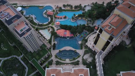 Aerial-view-of-Grand-Hotel-Ho-Tram-featuring-buildings,-swimming-pool-and-beach